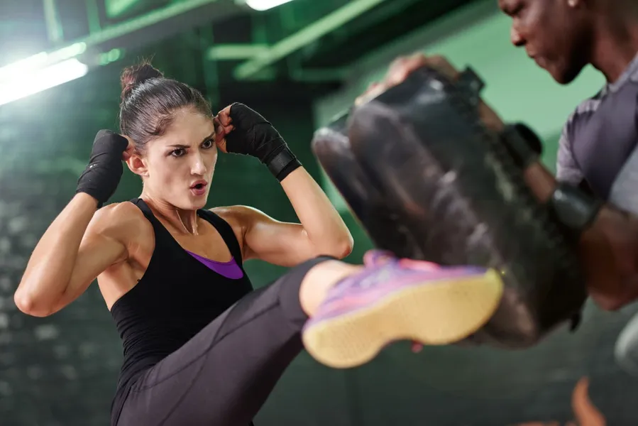 How to Train Like a Professional Fighter at Home Athlete training like a professional fighter at home with bodyweight exercises and shadowboxing